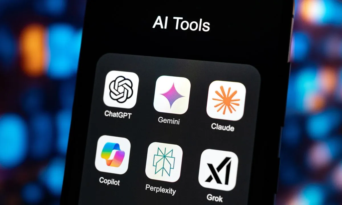 A smartphone screen showing AI tool icons including ChatGPT, Gemini, Claude, Copilot, Perplexity and Grok.